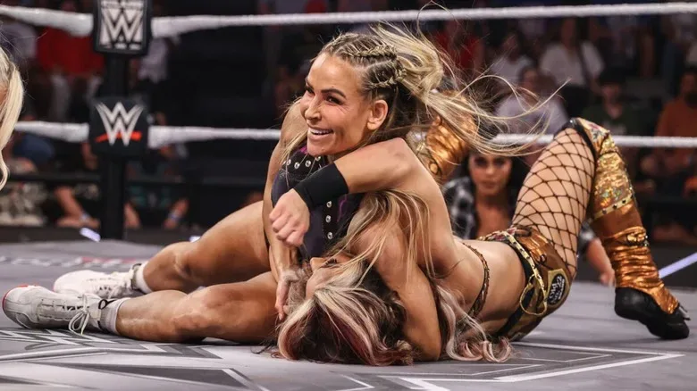 WWE star Nattie puts Thea Hail in a submission in the middle of the ring during a match on "WWE NXT."