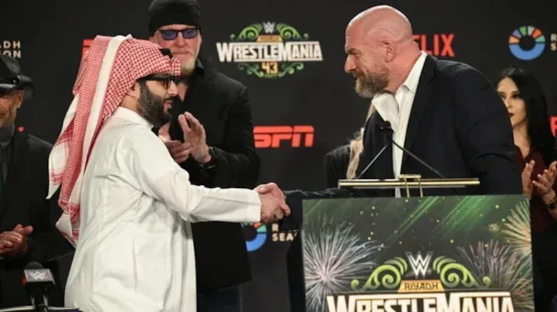Paul Levesque shaking hands with Turki Al-Sheikh