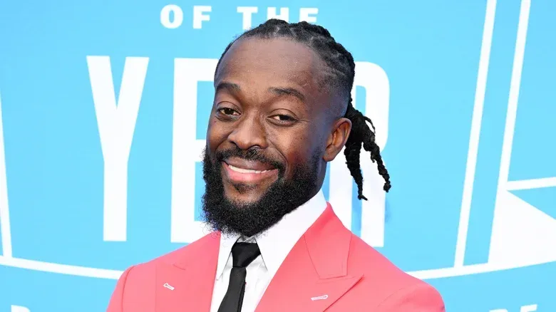 Kofi in front of a blue and white background