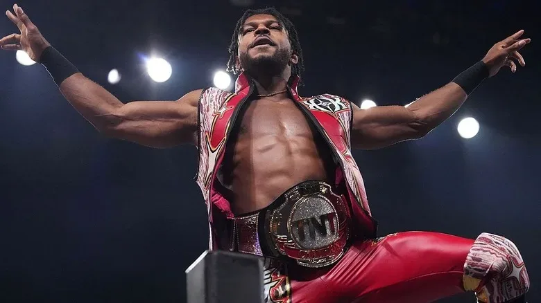 Kevin Knight posing with the TNT Championship at the top of the turnbuckle during his reign with the belt.