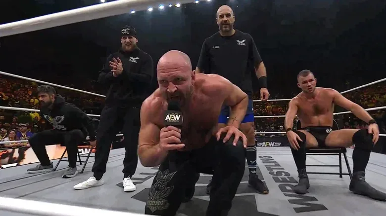 Jon Moxley flanked by the Death Riders