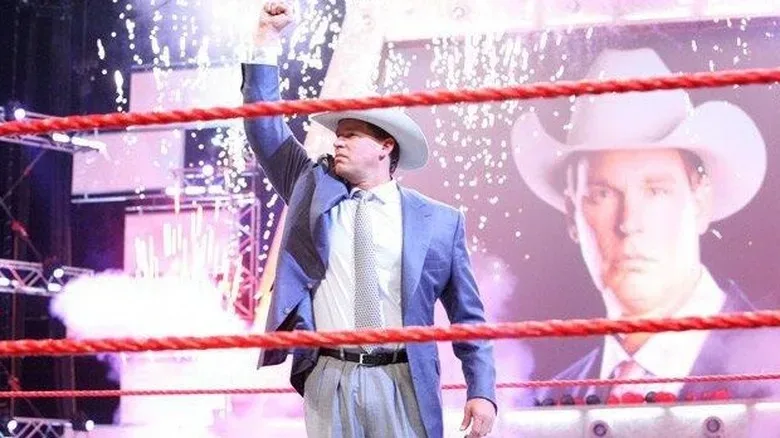 WWE Hall of Famer JBL poses in the center of the ring with the pyros going off in the back