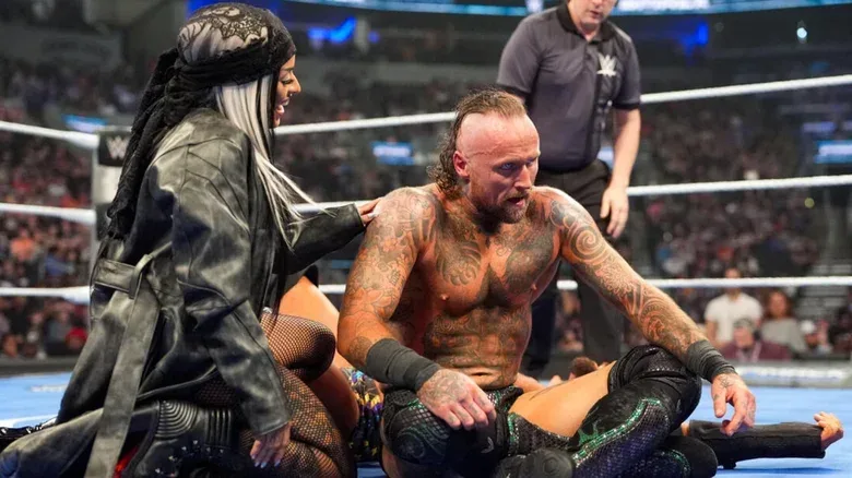 Xelina and Malakai Black sitting in a WWE ring