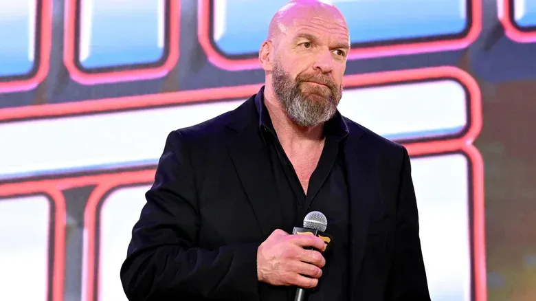 Paul Levesque with a microphone