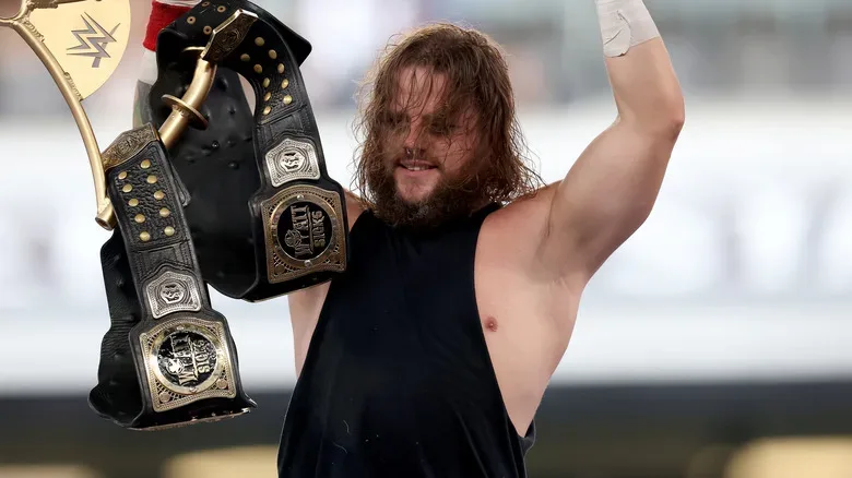 Joe Gacy with the tag team titles at SummerSlam