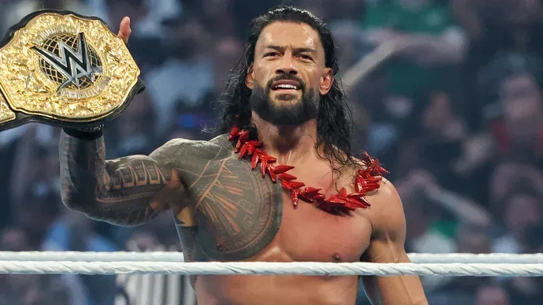 Roman Reigns celebrating with the World Heavyweight Championship after defeating CM Punk at WrestleMania 42.