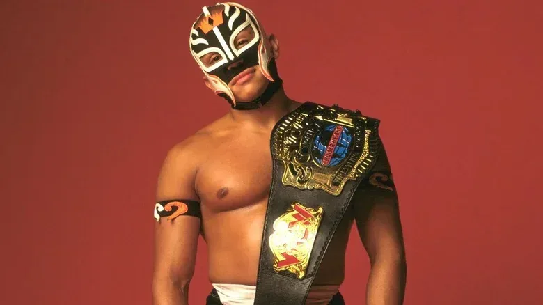 Rey Mysterio posing with the WCW Cruiserweight Championship during a photoshoot with the belt.