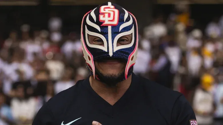 Rey Mysterio stands on the field before the MLB Mexico City Series game between the San Diego Padres and the Arizona Diamondbacks, Mexico City. April 2026.