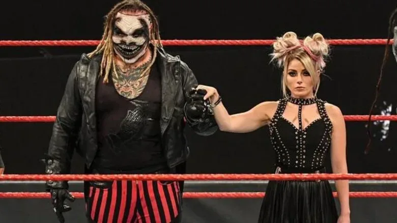 Bray Wyatt and Alexa Bliss hold hands in the middle of the ring during a segment with Retribution on an October 2020 edition of WWE programming.