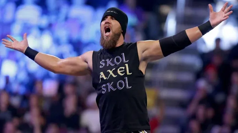 Curtis Axel, real name Joe Hennig, poses on the ropes before a match on an edition of WWE programming.