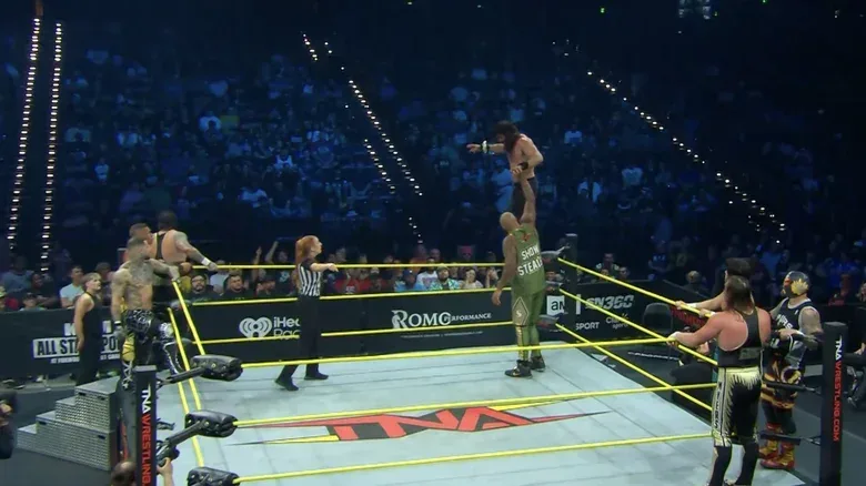 All eight men inside and around the ring