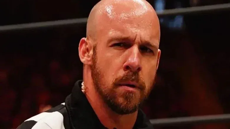 AEW referee Bryce Remsburg is picture with a confused look on his face during a match on an episode of AEW programming.