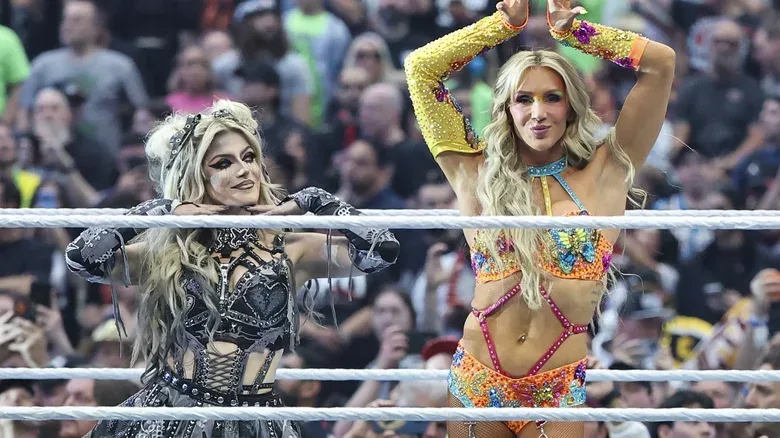 Alexa Bliss and Charlotte Flair posing in the ring