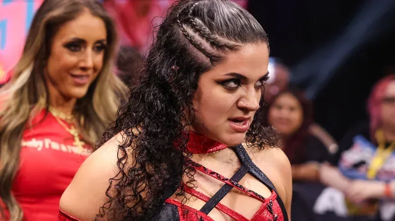 Persephone, flanked by Britt Baker, stares into the ring after a match on "AEW Collision."